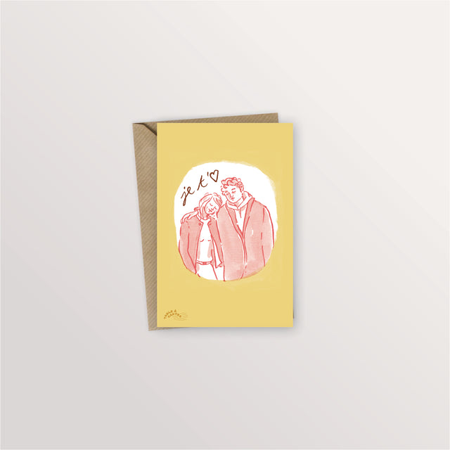 Carte postale « Je t'aime » : couple enlacé dans un médaillon rose sur fond jaune