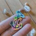 Sticker brillant « Ancre et sterne arctique » tenu entre les doigts, reflets holographiques